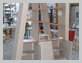 Librerie con funzione di parete divisoria locali in fase di realizzazione. Parte inferiore con sportelli sagomati e attrezzature interne, parte superiore passante.